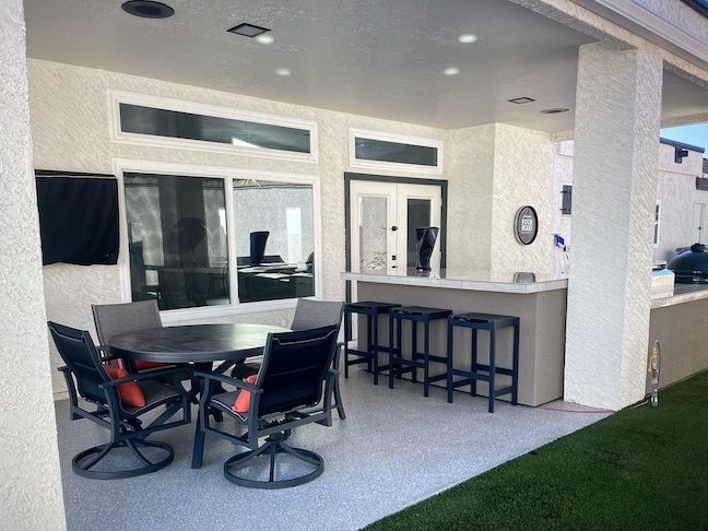 Covered patio polyaspartic coating with outdoor dining space — East Valley, AZ